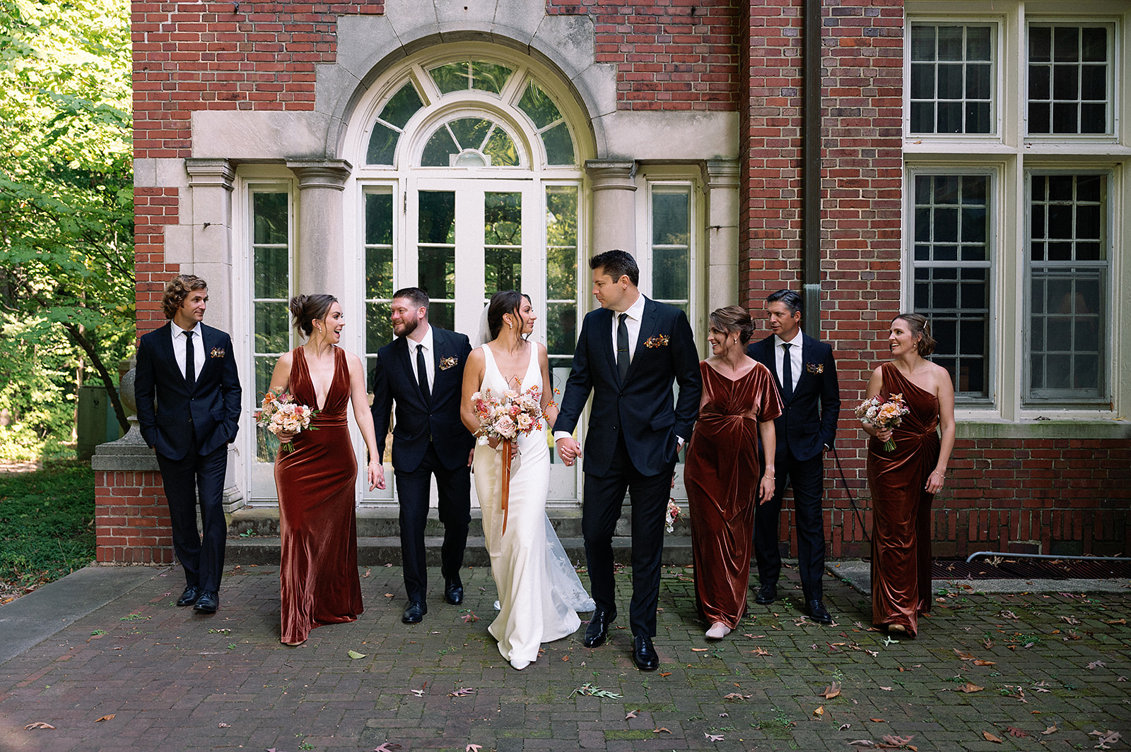 Outdoor fall wedding party photos at Holmdene Hall at Aquinas College