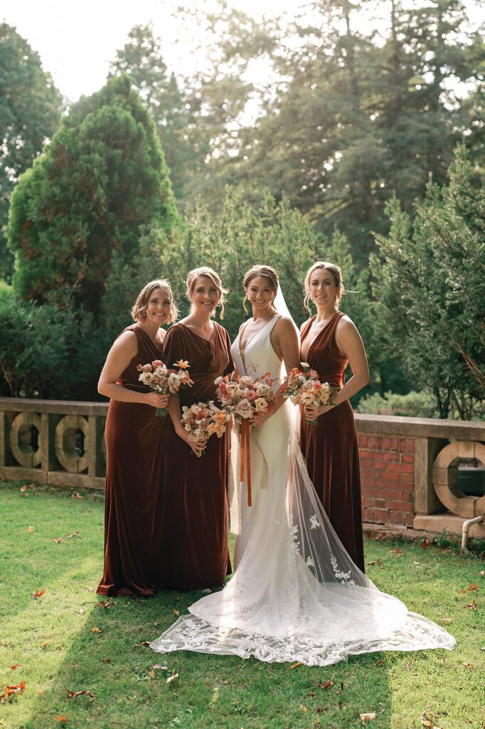 Outdoor fall bride and bridesmaids portraits at Holmdene Hall at Aquinas College