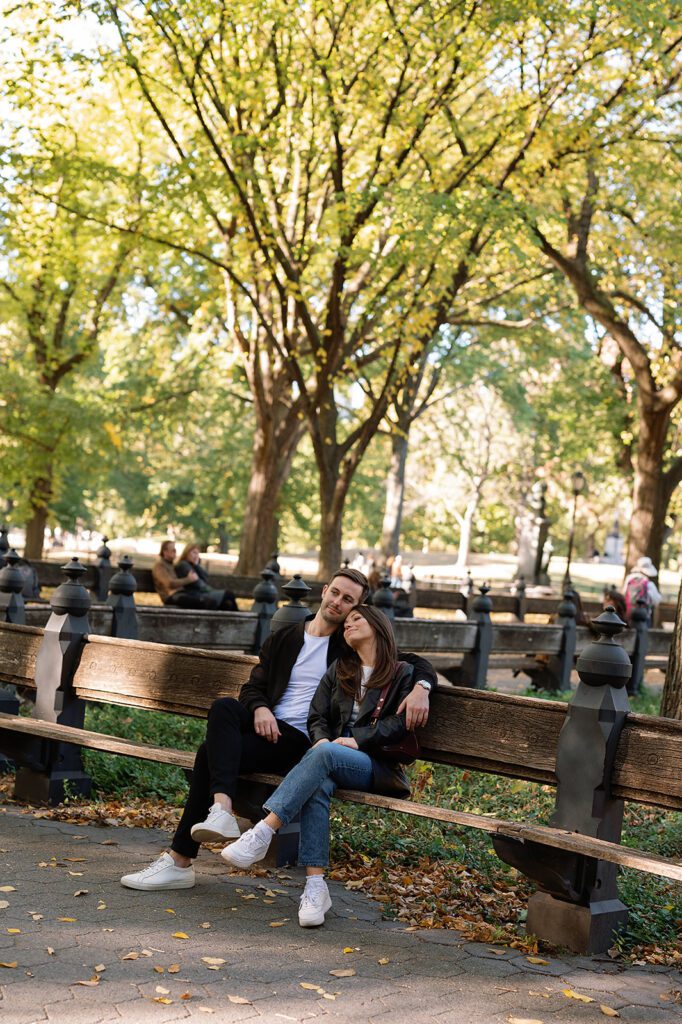 Couple sitting on a bench together in Central Park