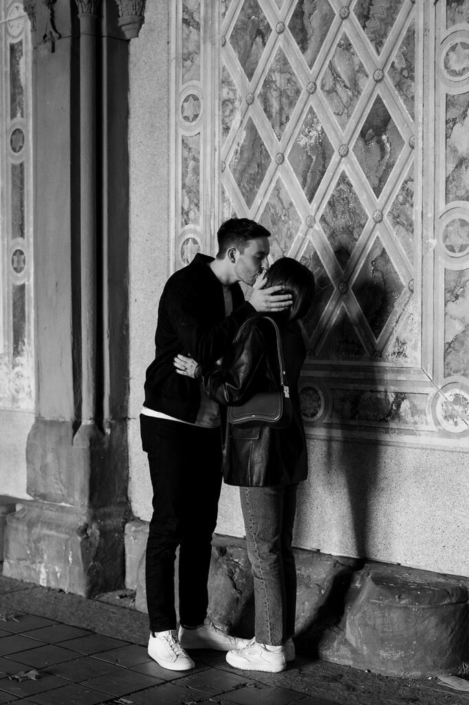 Couple kissing at Bethesda Terrace in Central Park