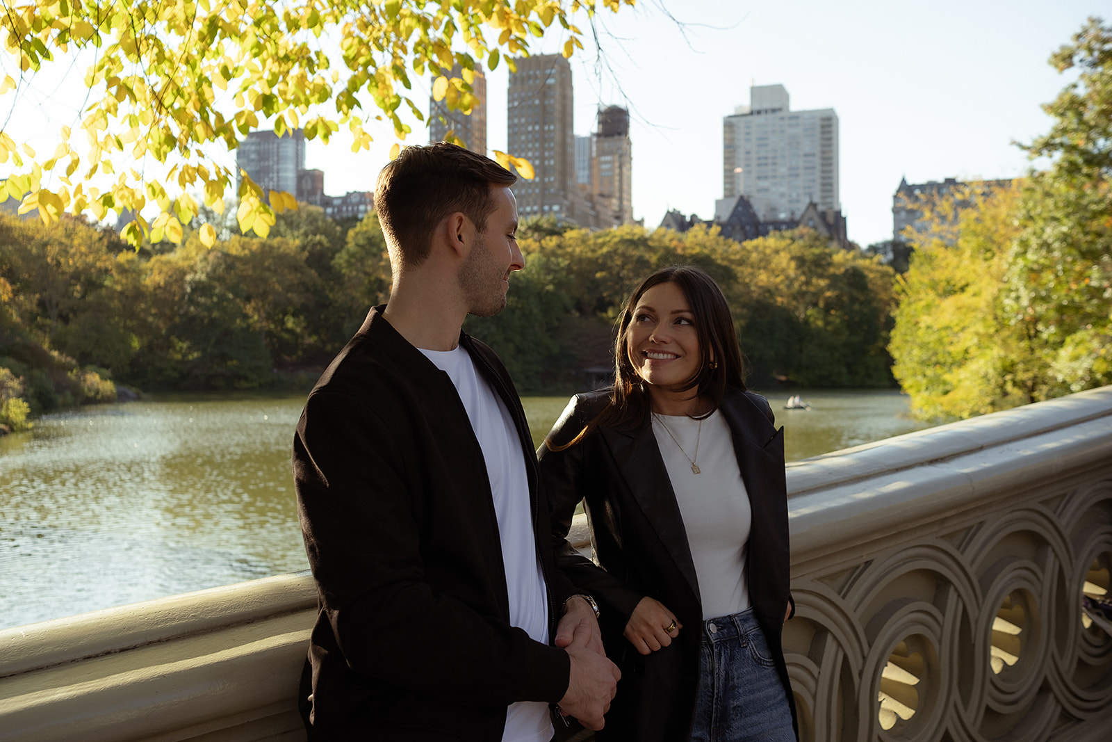 Couple standing on Bow Bridge for their Central Park NYC engagement photos