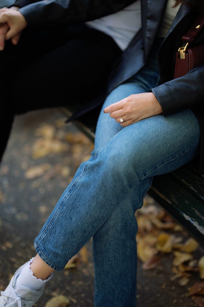 Close up of a couple sitting on a bench along The Mall in Central Park during fall.