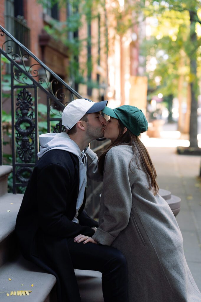 Couple kissing on the stoops of Greenwich Village for their NYC engagement photos