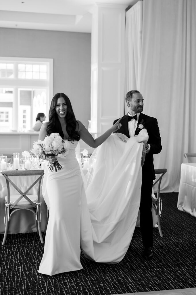 Bride and groom doing a wedding reception room reveal at Bay Harbor Yacht Club in the Lange Center Ballroom