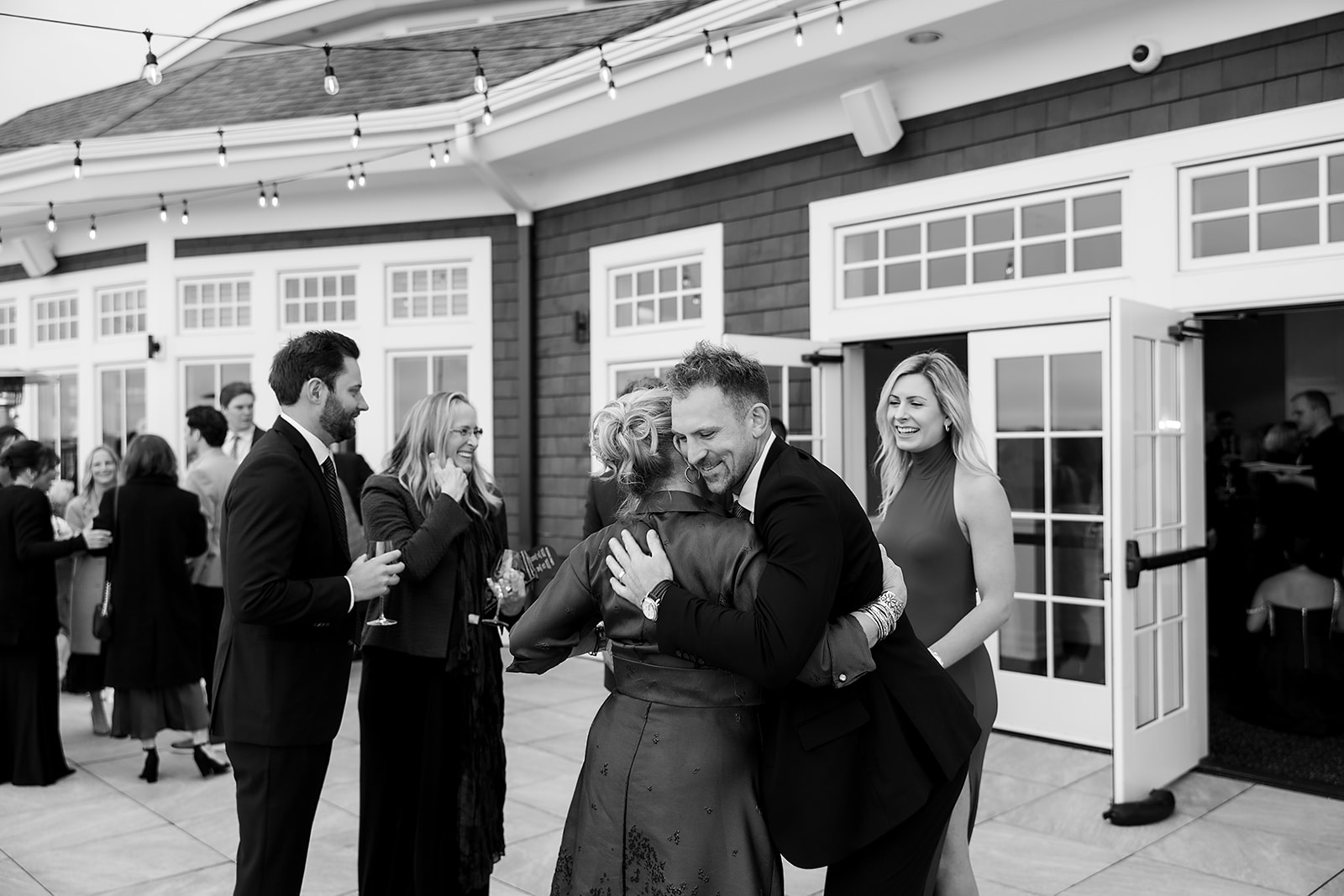 Guests hugging during cocktail hour at  Bay Harbor Yacht Club in Northern Michigan