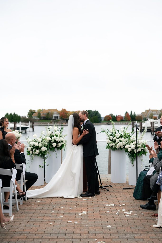 Bride and groom kissing during their Bay Harbor Yacht Club Promenade Dock wedding ceremony
