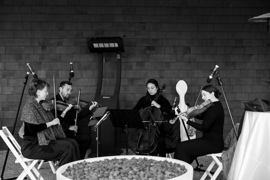 String quartet performing during a waterfront wedding ceremony at Bay Harbor Yacht Club.