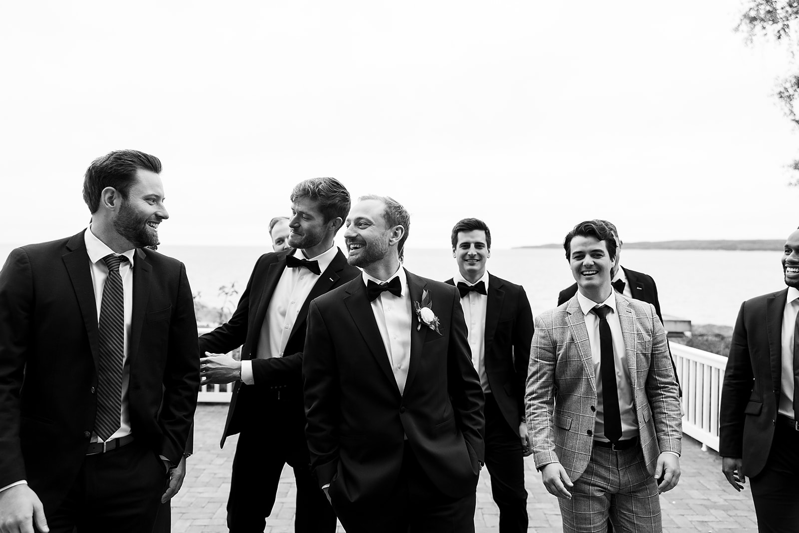Black and white photo of the groom with his groomsmen at Bay Harbor Yacht Club wedding venue in Northern Michigan
