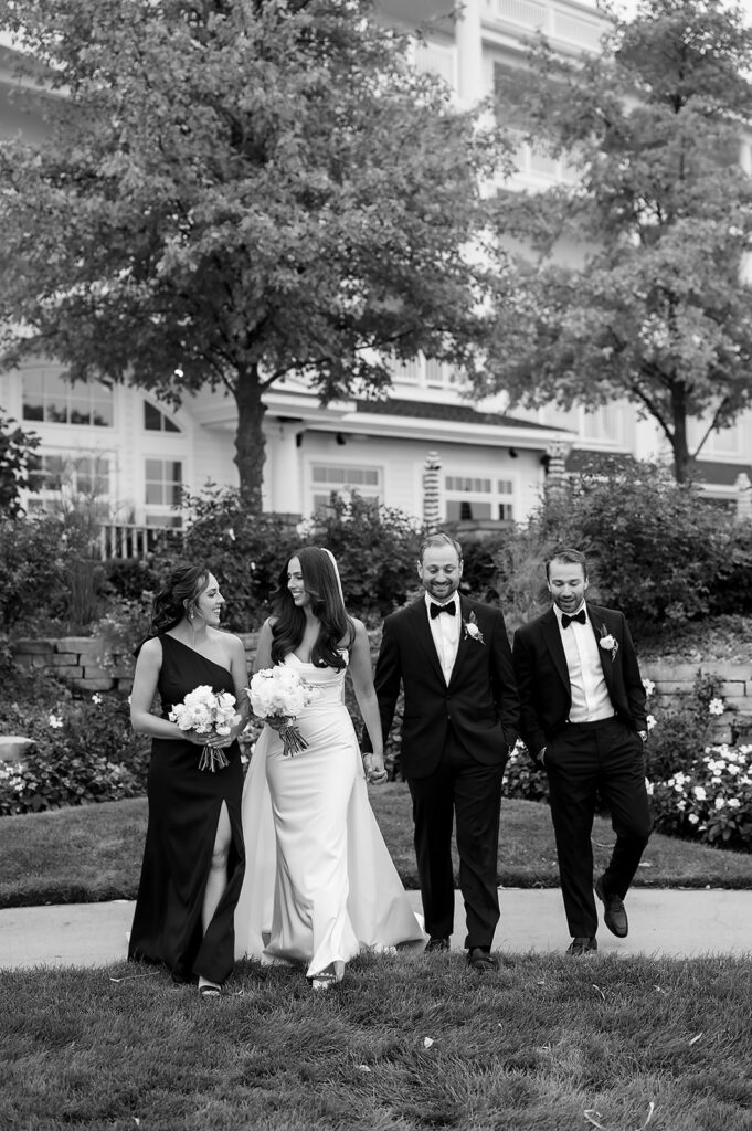 Black and white photo of the bride and groom with their wedding party at Bay Harbor Yacht Club wedding venue in Northern Michigan