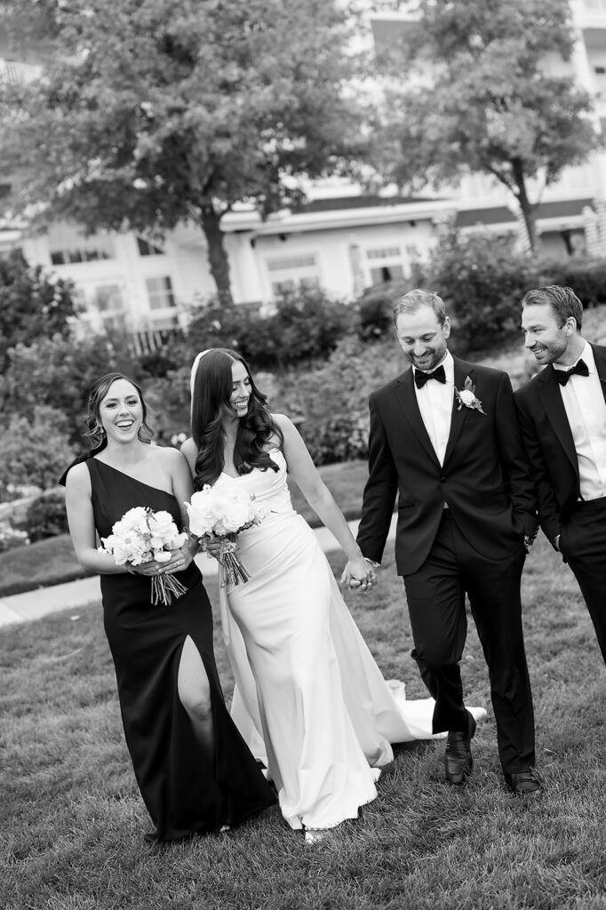 Black and white photo of the bride and groom with their wedding party at Bay Harbor Yacht Club wedding venue in Northern Michigan