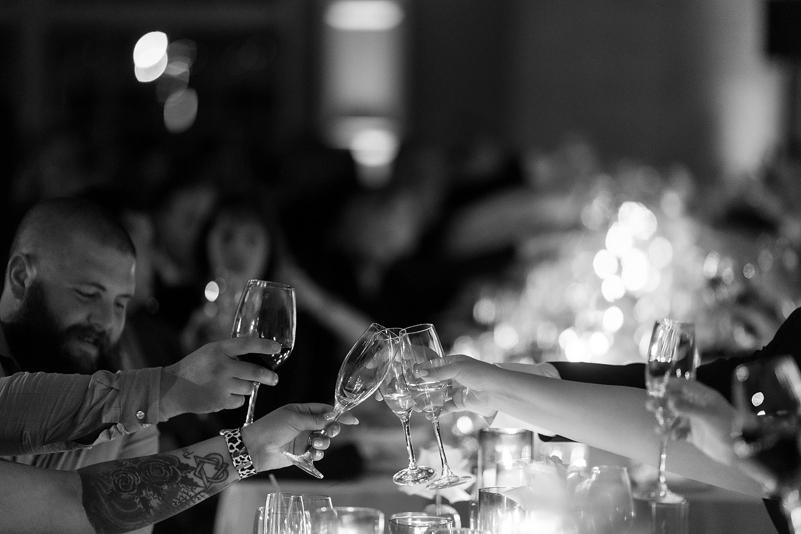 Black and white photo of champagne glasses clinking