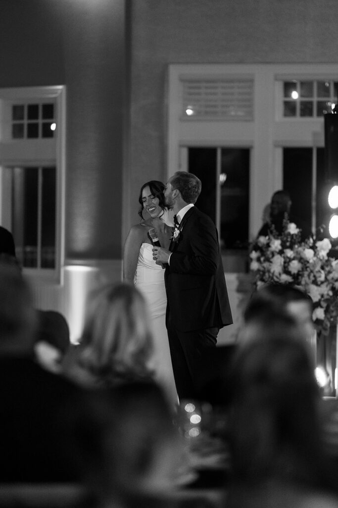 Bride and groom giving a speech during their reception