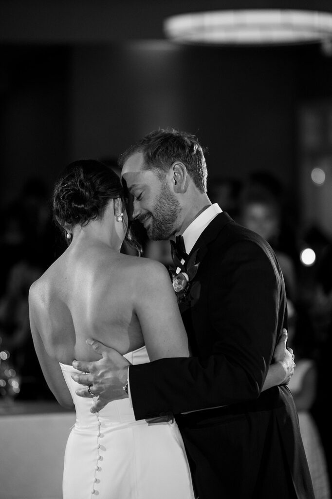Black and white photo of the bride and groom sharing a first dance for their Bay Harbor Yacht Club wedding reception in Northern Michigan