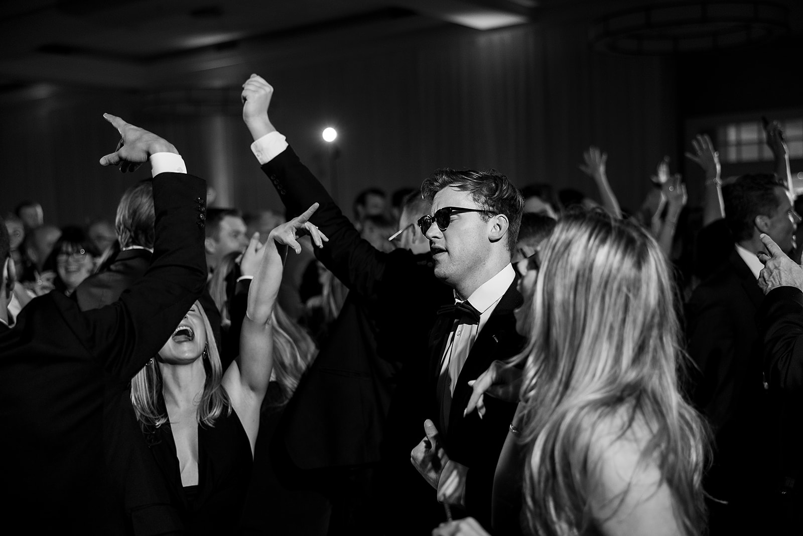 Black and white photo of guests dancing during a Bay Harbor Yacht Club wedding reception in Northern Michigan 