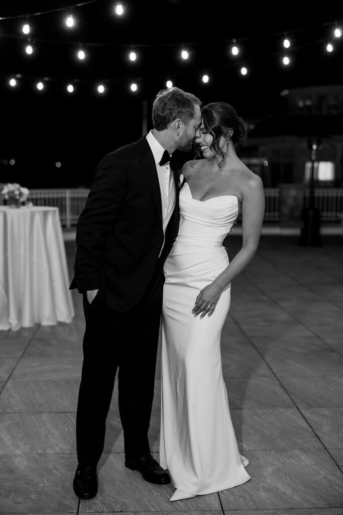Black and white photo of a bride and groom touching foreheads during their Bay Harbor Yacht Club wedding reception in Northern Michigan