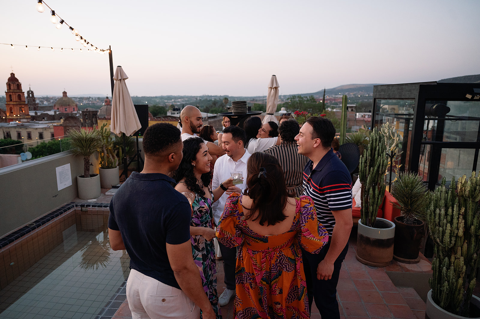 Guests mingling and enjoying drinks during a San Miguel de Allende wedding welcome party at Bekeb