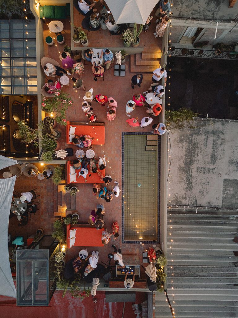 Aerial view of the Bekeb rooftop wedding welcome party in San Miguel de Allende showing guests mingling around the pool.