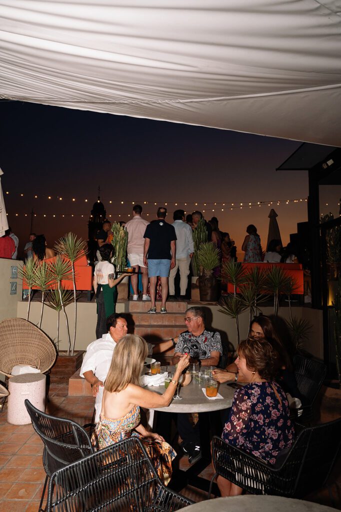 Guests mingling at sunset during a San Miguel de Allende wedding welcome party at Bekeb