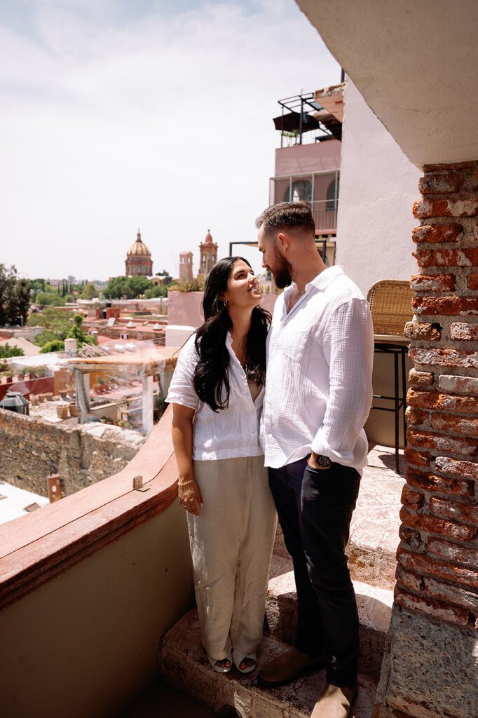 Couple smiling at each other during their farewell brunch weekend in San Miguel de Allende.