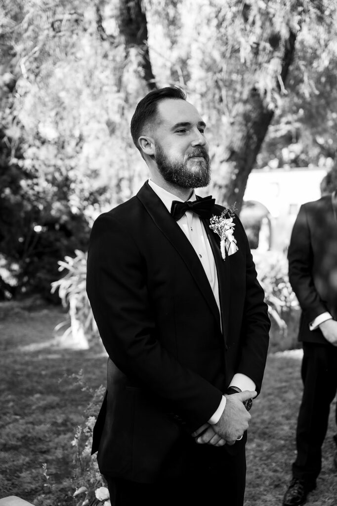 Groom waiting at the altar during outdoor wedding ceremony
