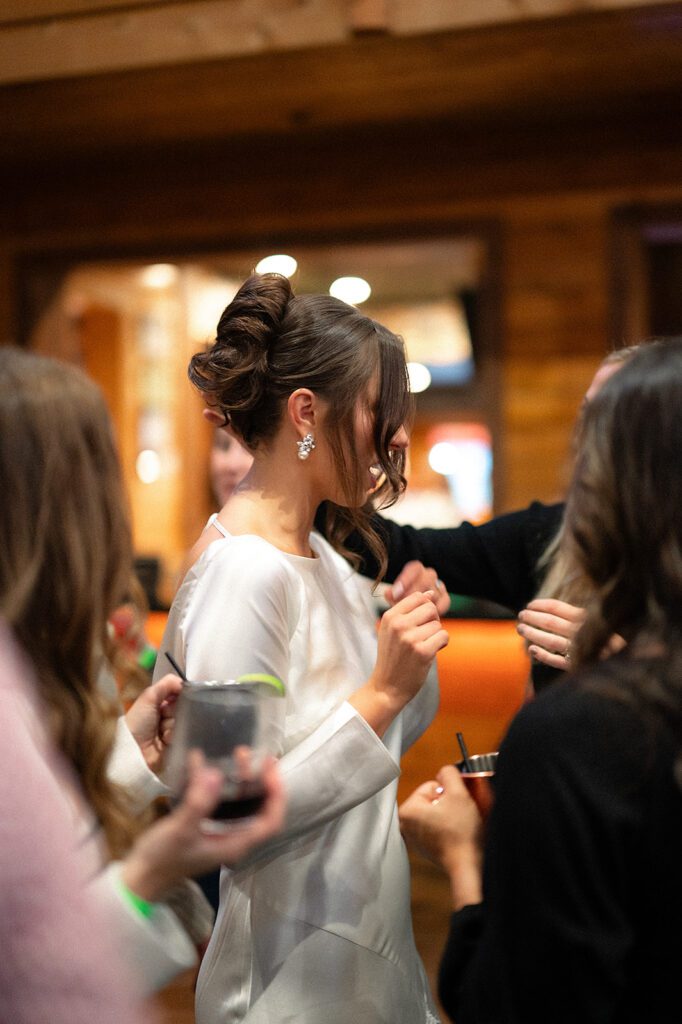 Bride mingling with guests during her welcome wedding party in Northern Michigan