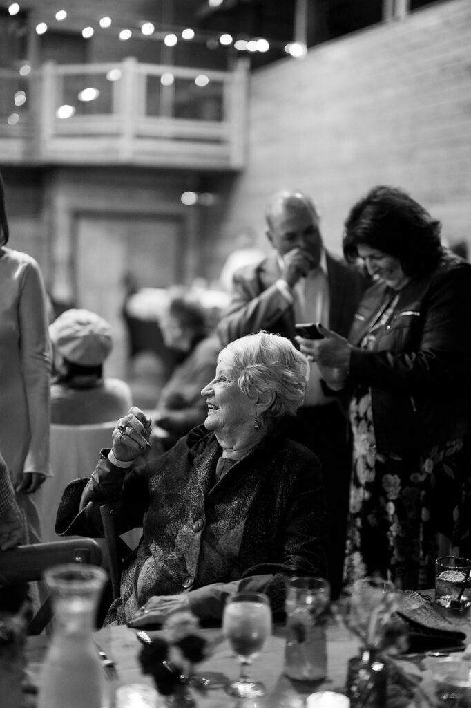 Black and white photo of guests mingling during a Northern Michigan wedding welcome party