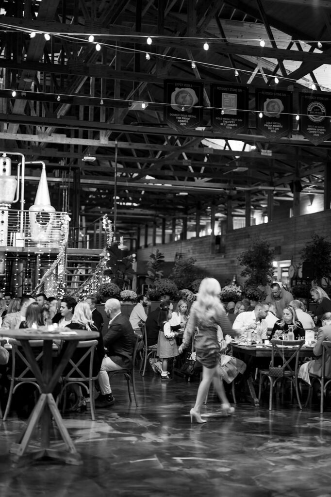 Black and white photo of guests mingling during a Northern Michigan wedding welcome party