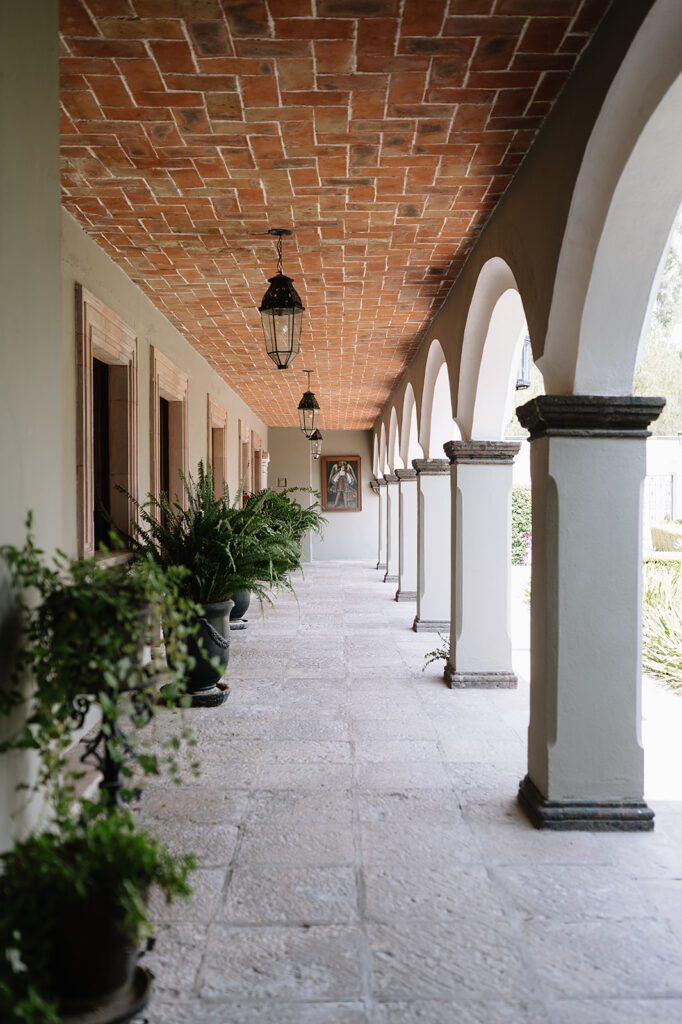 Outdoor hallway with arches and plants at Hacienda San Luis Gonzaga wedding venue