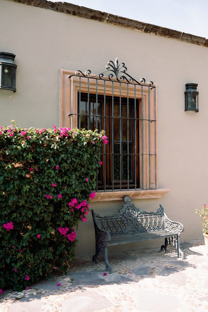 Exterior window and bench with flowers at Hacienda San Luis Gonzaga in San Miguel de Allende