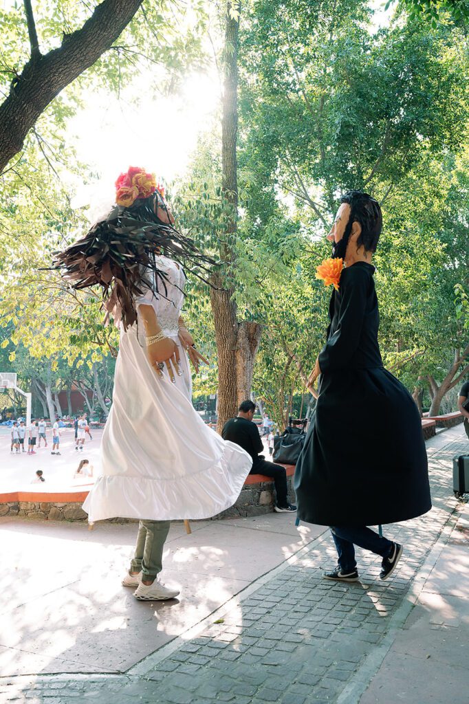 Traditional giant puppets, known as mojigangas, dance during the lively callejoneada parade in San Miguel de Allende.