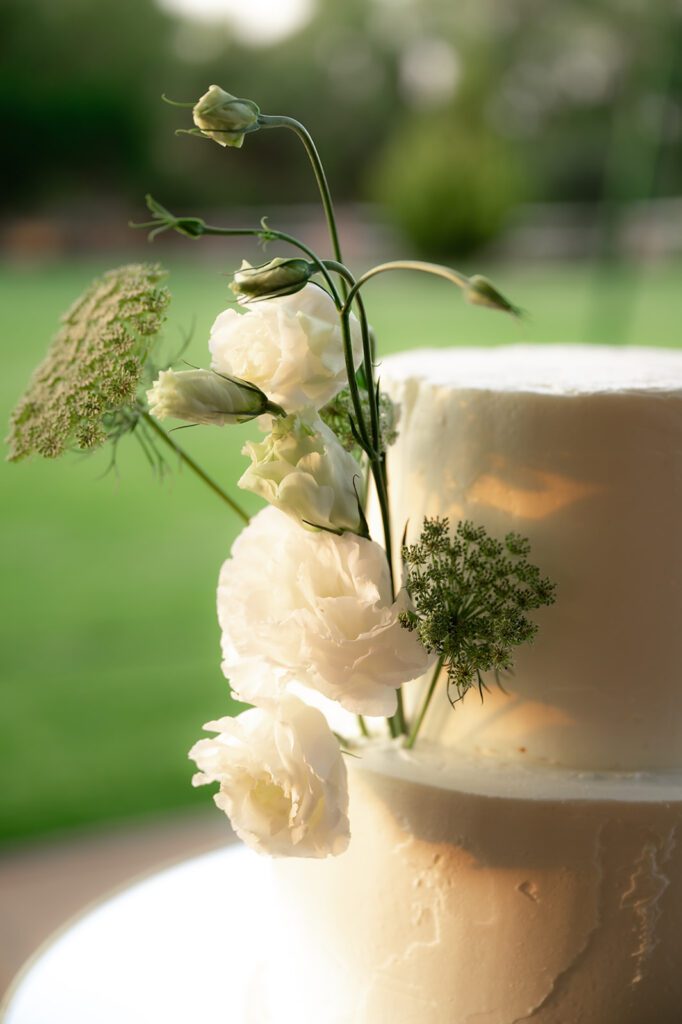 Close up shot of a two tiered wedding cake with florals