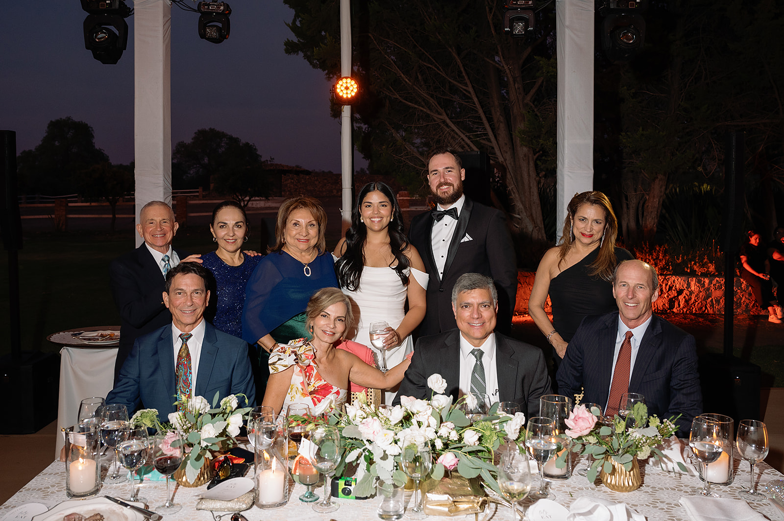 Bride and groom posing with family