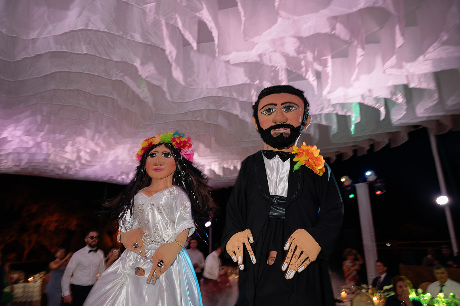 Traditional giant puppets performing during la hora loca at Hacienda San Luis Gonzaga wedding reception.