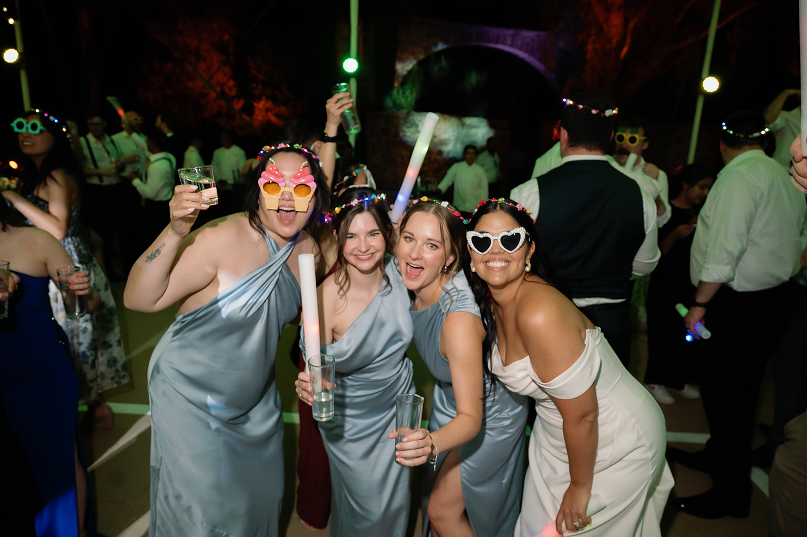 Bride posing with bridesmaids during the reception