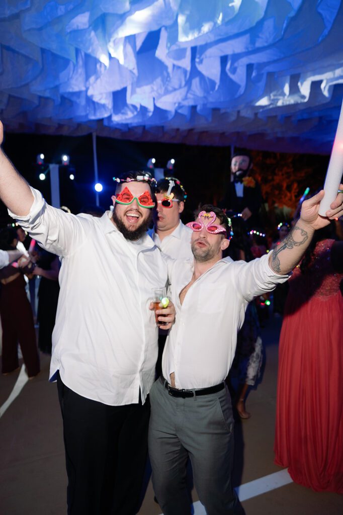 Guests posing for a photo with sunglasses on