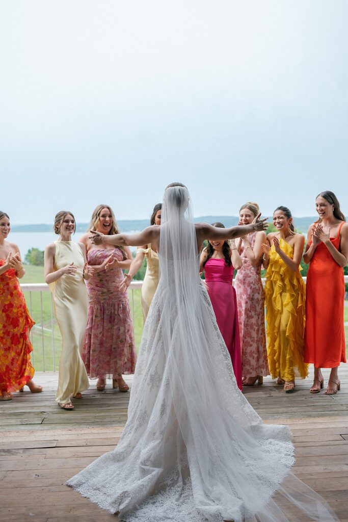 Bride sharing a first look with her bridesmaids at Noverr Farms in Traverse City, Michigan.