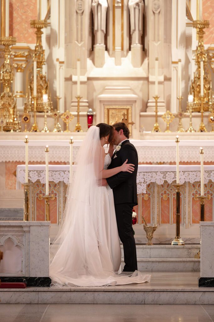 First kiss during a Sweetest Heart of Mary Church wedding ceremony.