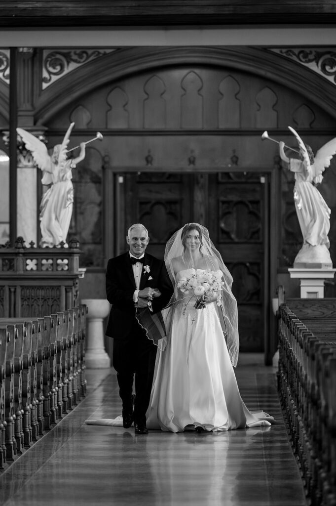 Bride walking down the longest wedding aisle in Detroit at Sweetest Heart of Mary Church.