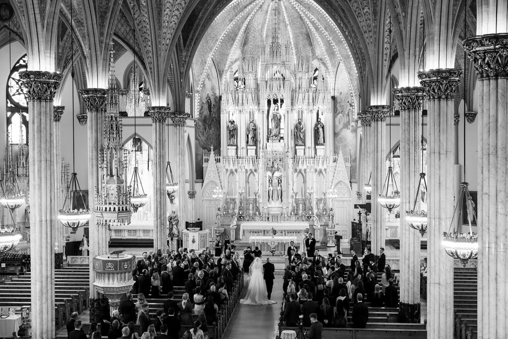 Wide view of Sweetest Heart of Mary Church interior during a Detroit wedding ceremony.
