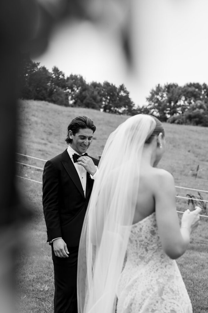 Groom admiring the bride in her dress during their first look.