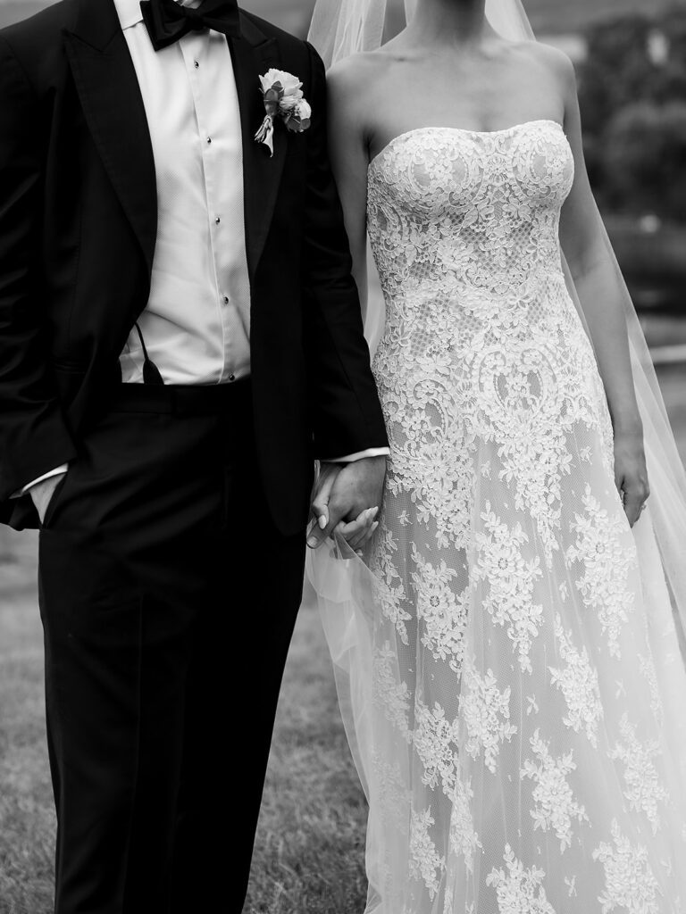 Close-up of bride and groom holding hands during their Traverse City wedding at Noverr Farms.