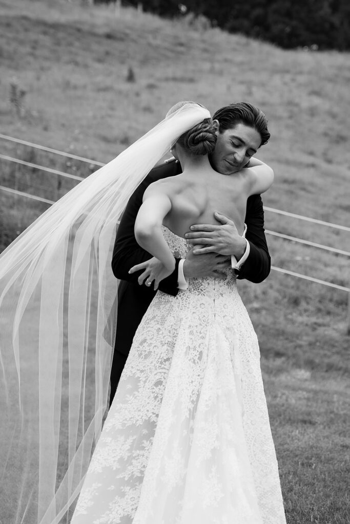 Bride and groom embrace during an emotional first look at their Traverse City wedding.