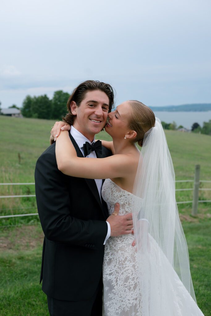 Bride and groom smiling and laughing during their Traverse City, Michigan wedding portraits.