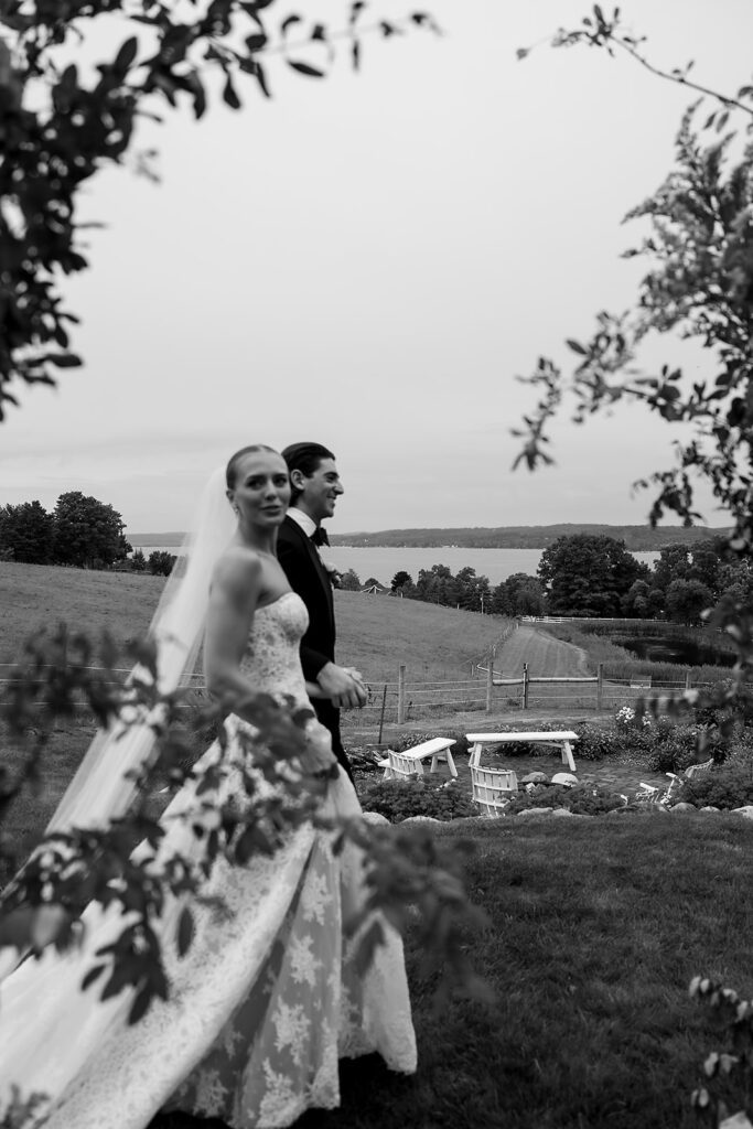 Bride and groom walking back to the venue together hand in hand.