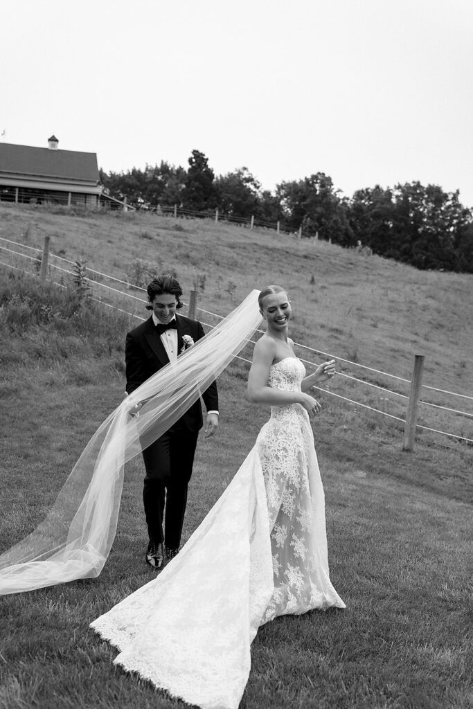 Groom admiring the bride in her dress during their first look at Noverr Farms.