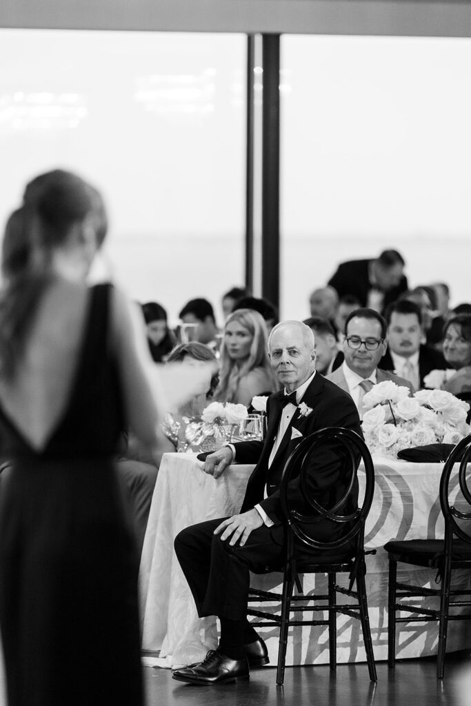 Black and white photo of guests listening to speeches.