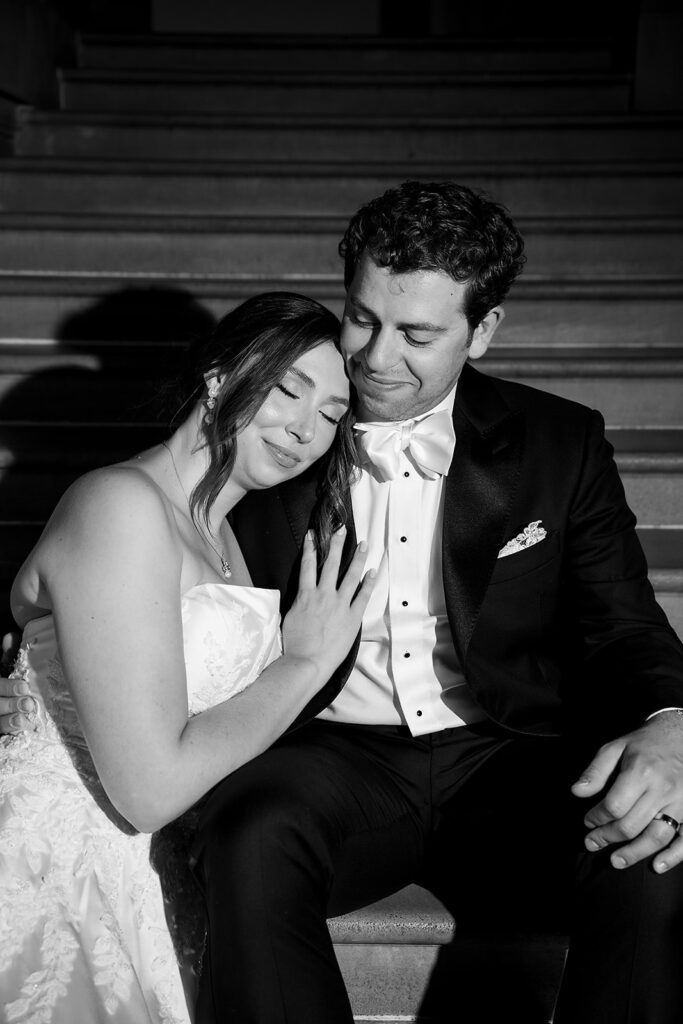 Flash photo of a bride and groom sitting on a staircase at Grosse Pointe War Memorial.
