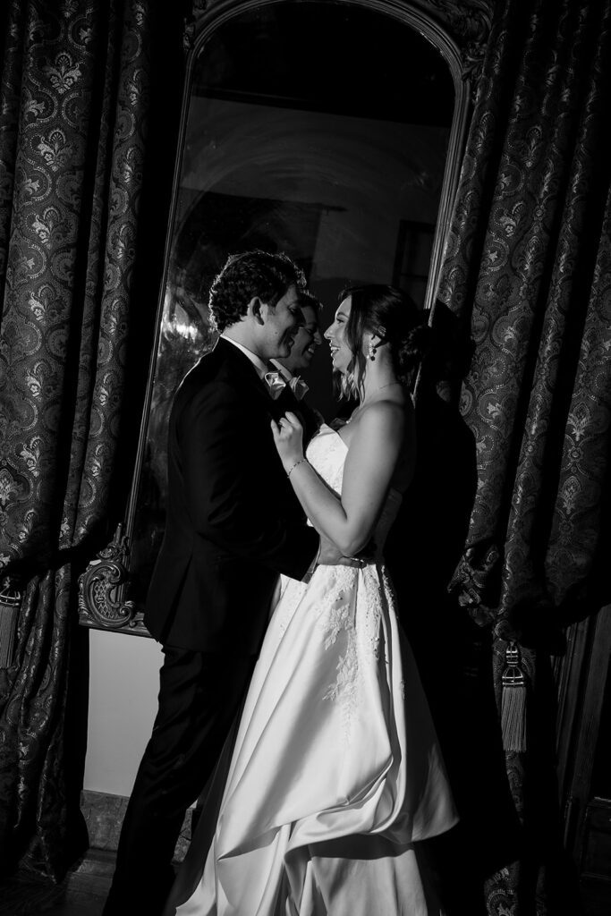 Black and white flash photo of a bride and groom poising at Grosse Pointe War Memorial.