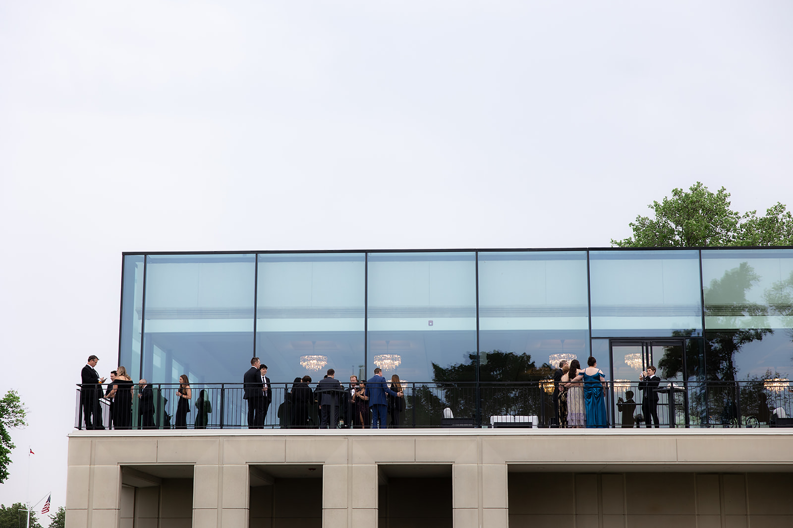 Guests mingling on the balcony patio.