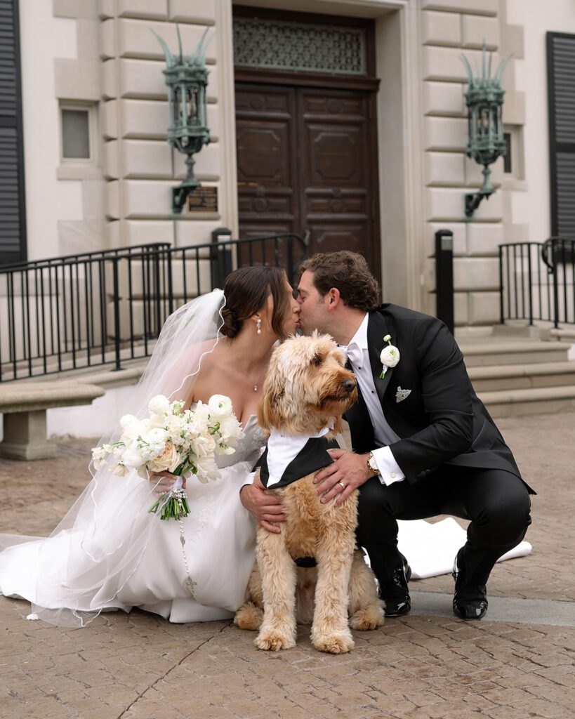 Bride and groom kissing with their dog during The War Memorial wedding portraits.